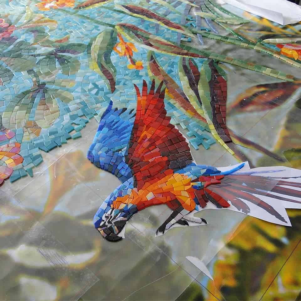 Macaw bird glass mosaic tile close-up.