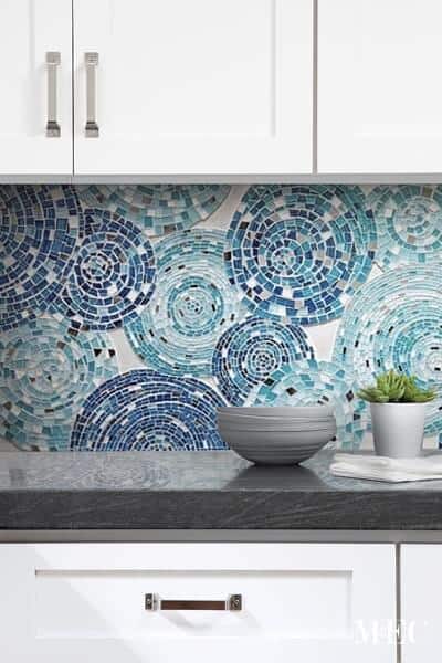 Decorative handcrafted mosaic tile backsplash art featuring whimsical circles in shades of blue
