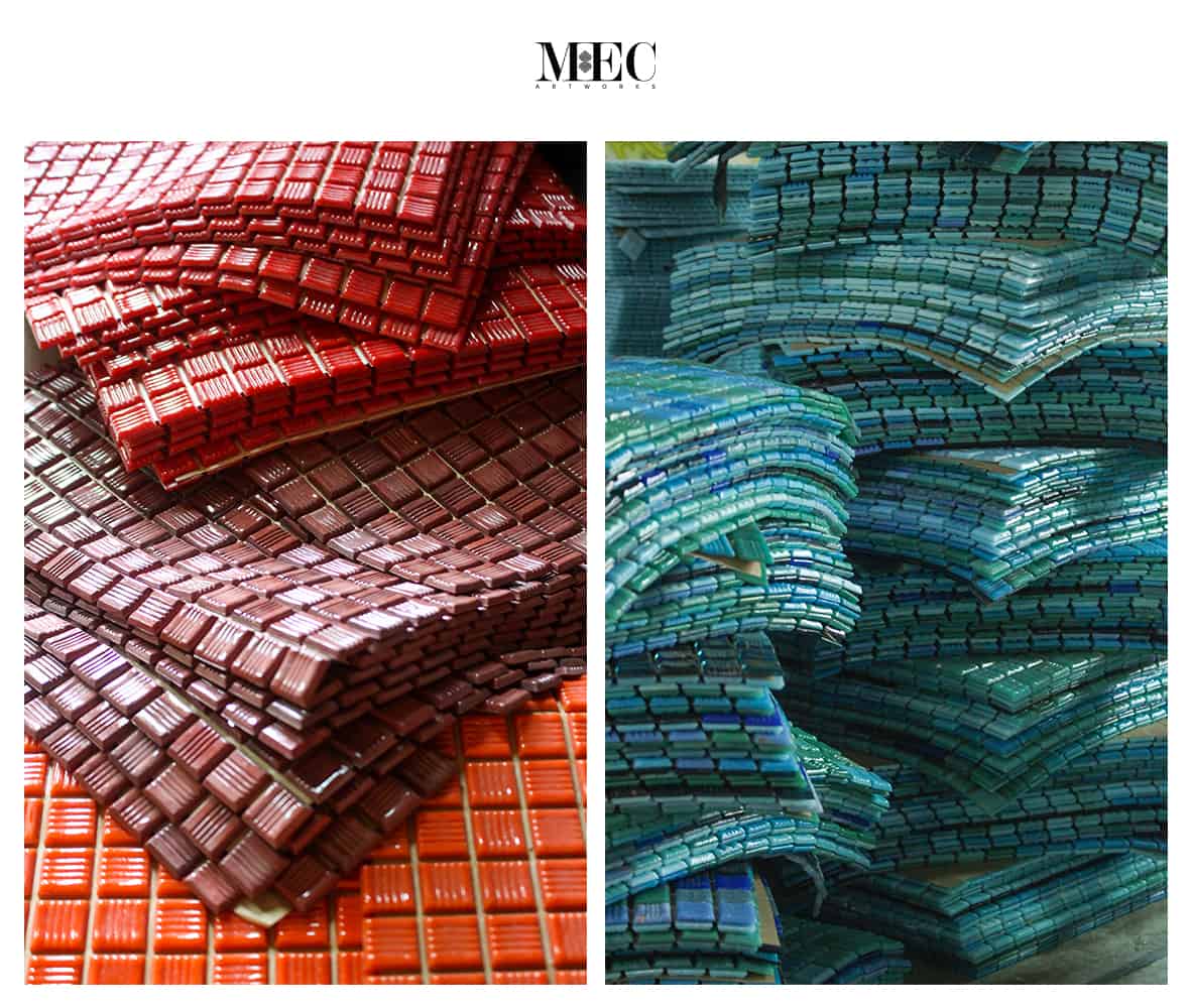 Stacks of shiny mosaic tiles in red, brown, orange, blue, and green