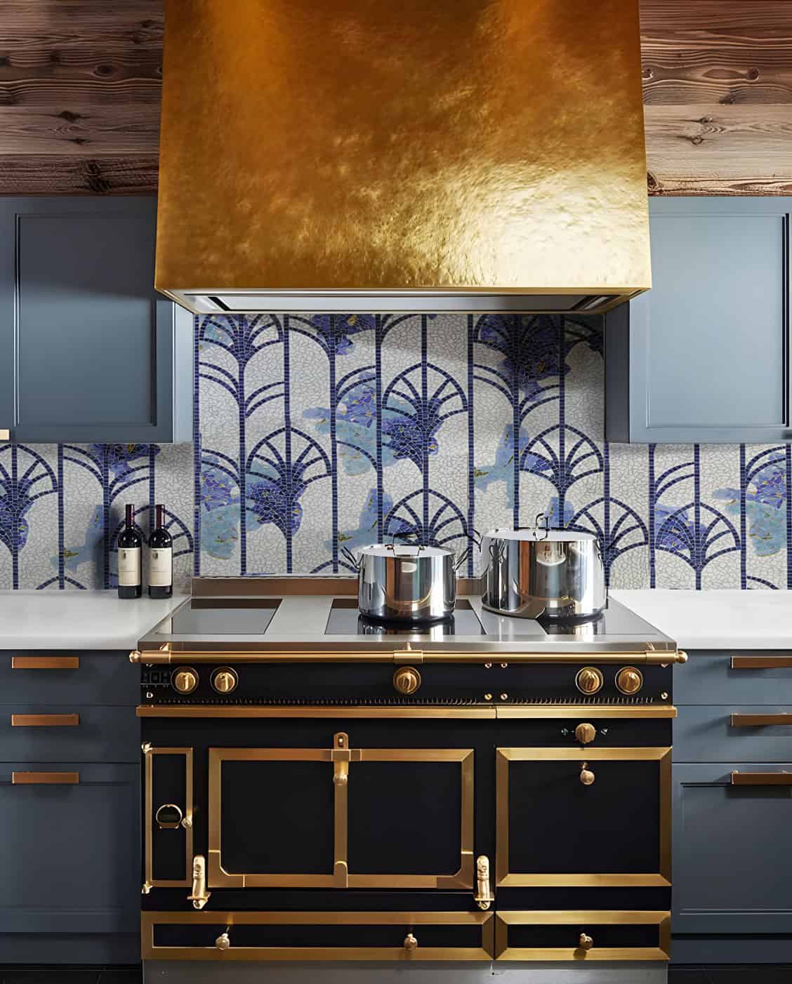 Blue and gold tiled kitchen with a gold hood, featuring a blue and white designed backsplash.