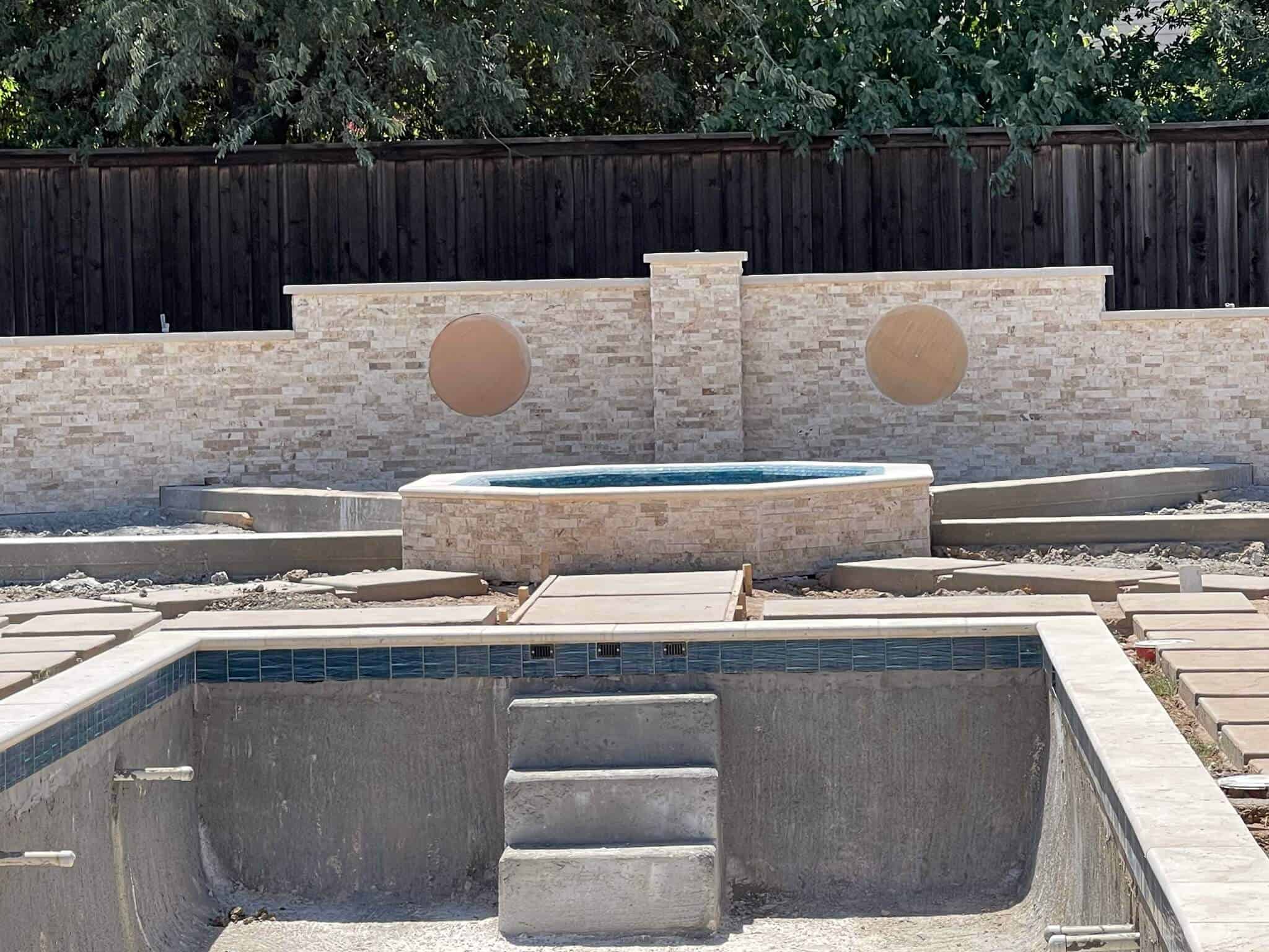 outdoor poolside area wall image shared by a client with spaces for mosaic medallions left on the wall